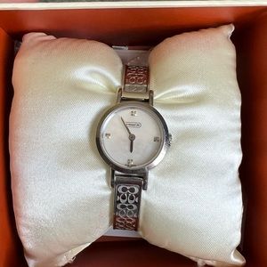 Coach women’s mini band watch.